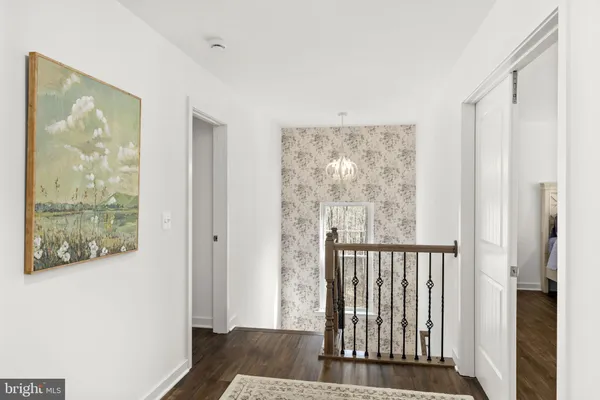a bedroom with a bed and a flat tv screen on dresser
