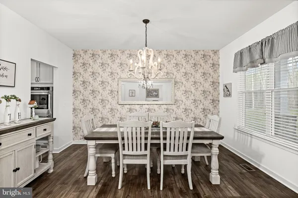 a view of a kitchen with furniture and wooden floor