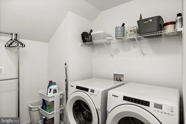 a backyard of a house with barbeque oven table and chairs