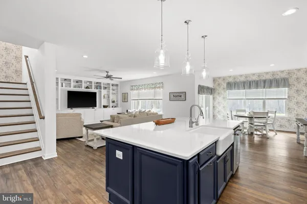 a kitchen with white cabinets and appliances