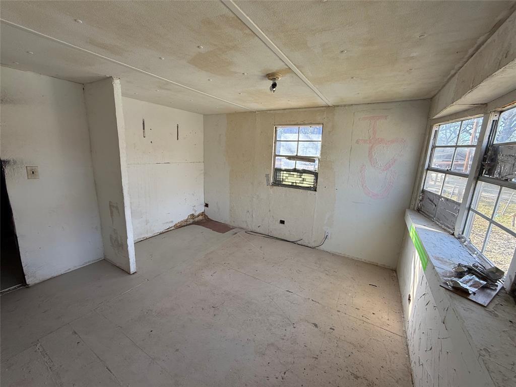 10300 Tanglewood Circle, Unit 1 Wills Point, TX 75169 - Photo 12 of 13 a view of an empty room with a window