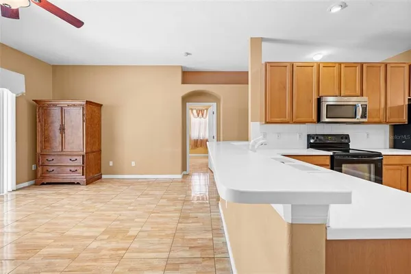 a kitchen with stainless steel appliances a stove refrigerator sink and microwave