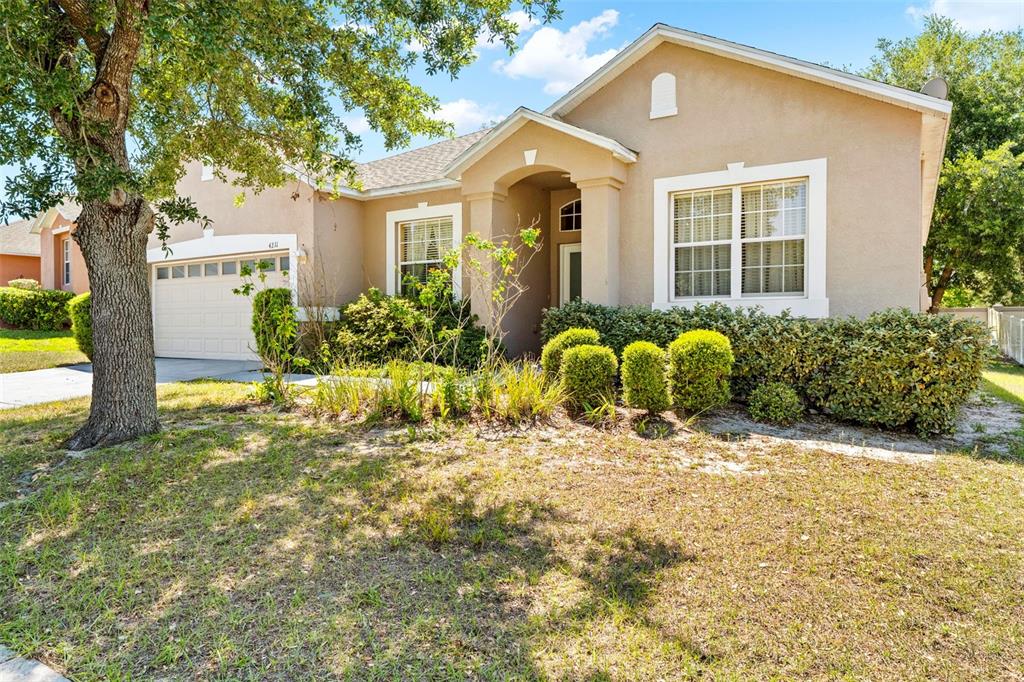 4211 Blakemore Place Spring Hill, FL 34609 - Photo 2 of 42 a front view of a house with garden