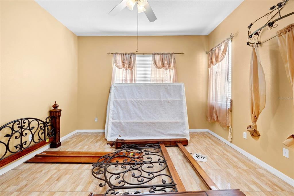 4211 Blakemore Place Spring Hill, FL 34609 - Photo 23 of 42 a bedroom with a bed and a rug