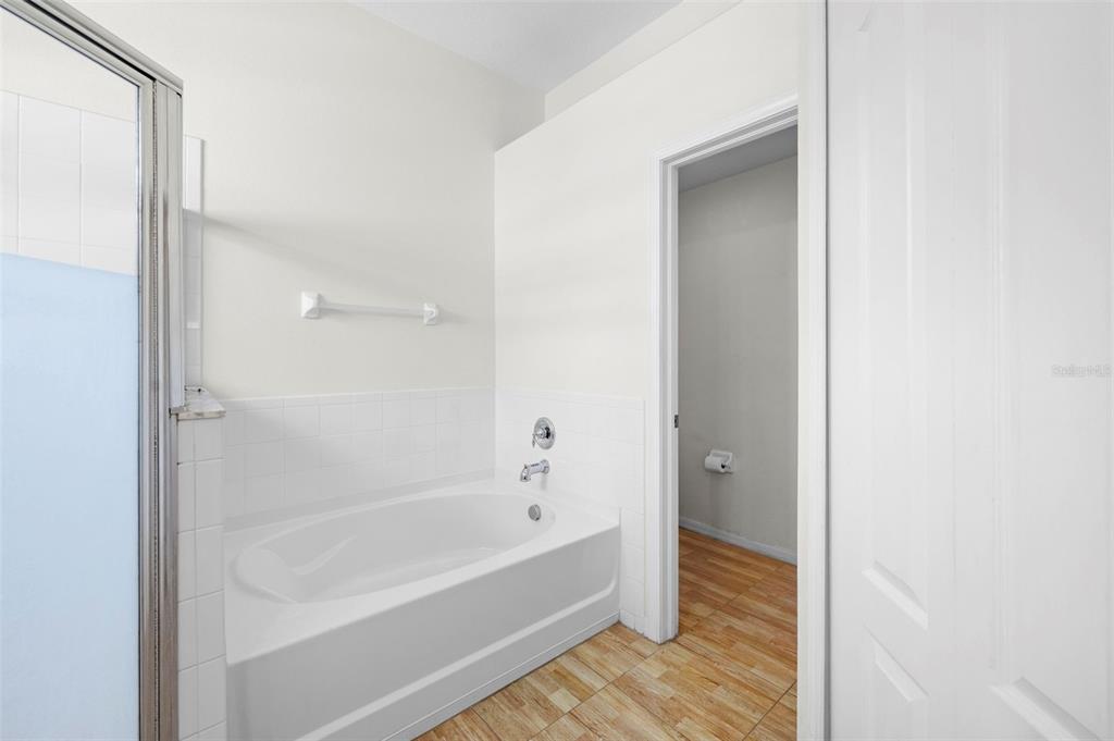 4211 Blakemore Place Spring Hill, FL 34609 - Photo 26 of 42 a bathroom with a bathtub and shower