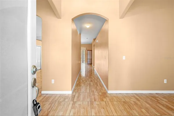 a view of a hallway with wooden floor