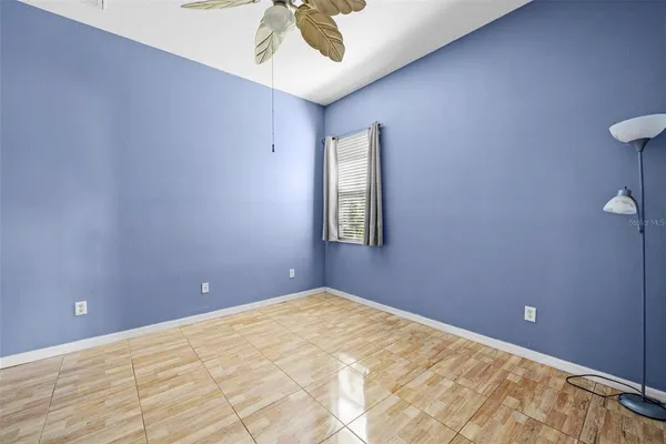 a view of a room with a ceiling fan and a window