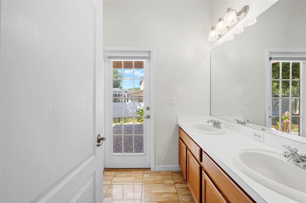 4211 Blakemore Place Spring Hill, FL 34609 - Photo 34 of 42 a bathroom with a sink a vanity and a mirror