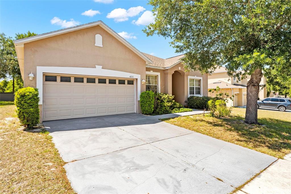 4211 Blakemore Place Spring Hill, FL 34609 - Photo 39 of 42 a front view of a house with garden