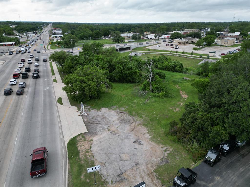116 East Highway 199 Springtown, TX 76082 - Photo 8 of 15 Expansive vacant land parcel featuring partial paved access and surrounding mature trees