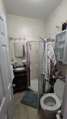 a bathroom with a sink toilet and shower