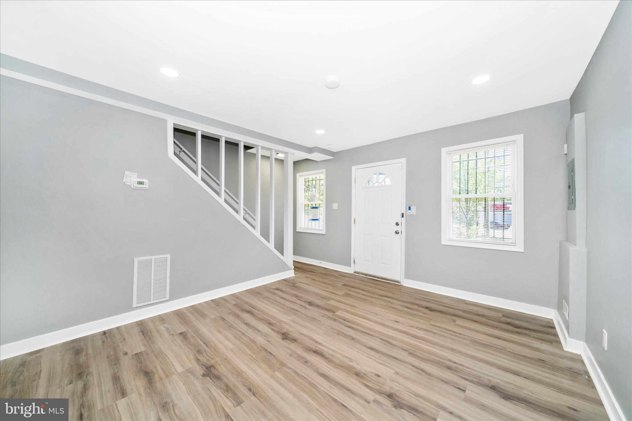 5027 Benning Road Southeast Washington, DC 20019 - Photo 10 of 57 a view of an empty room with wooden floor and a window