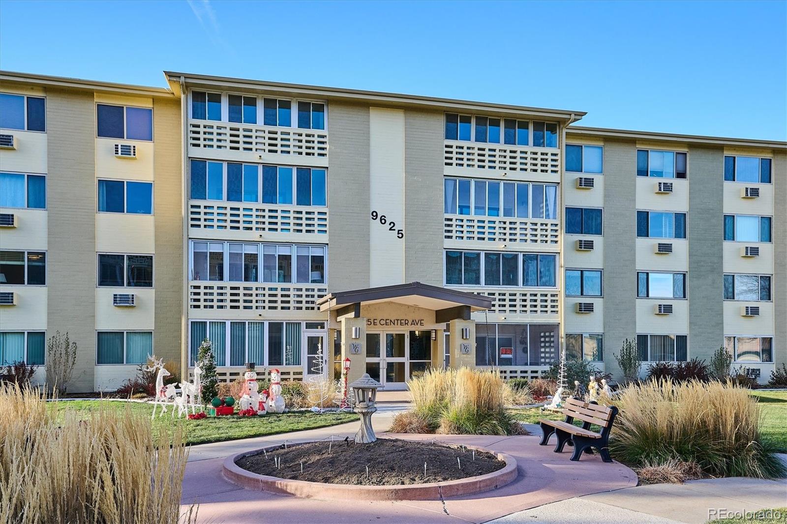 9625 Center Avenue, Unit 7B Denver, CO 80247 - Photo 19 of 49 a front view of a building with a garden and plants