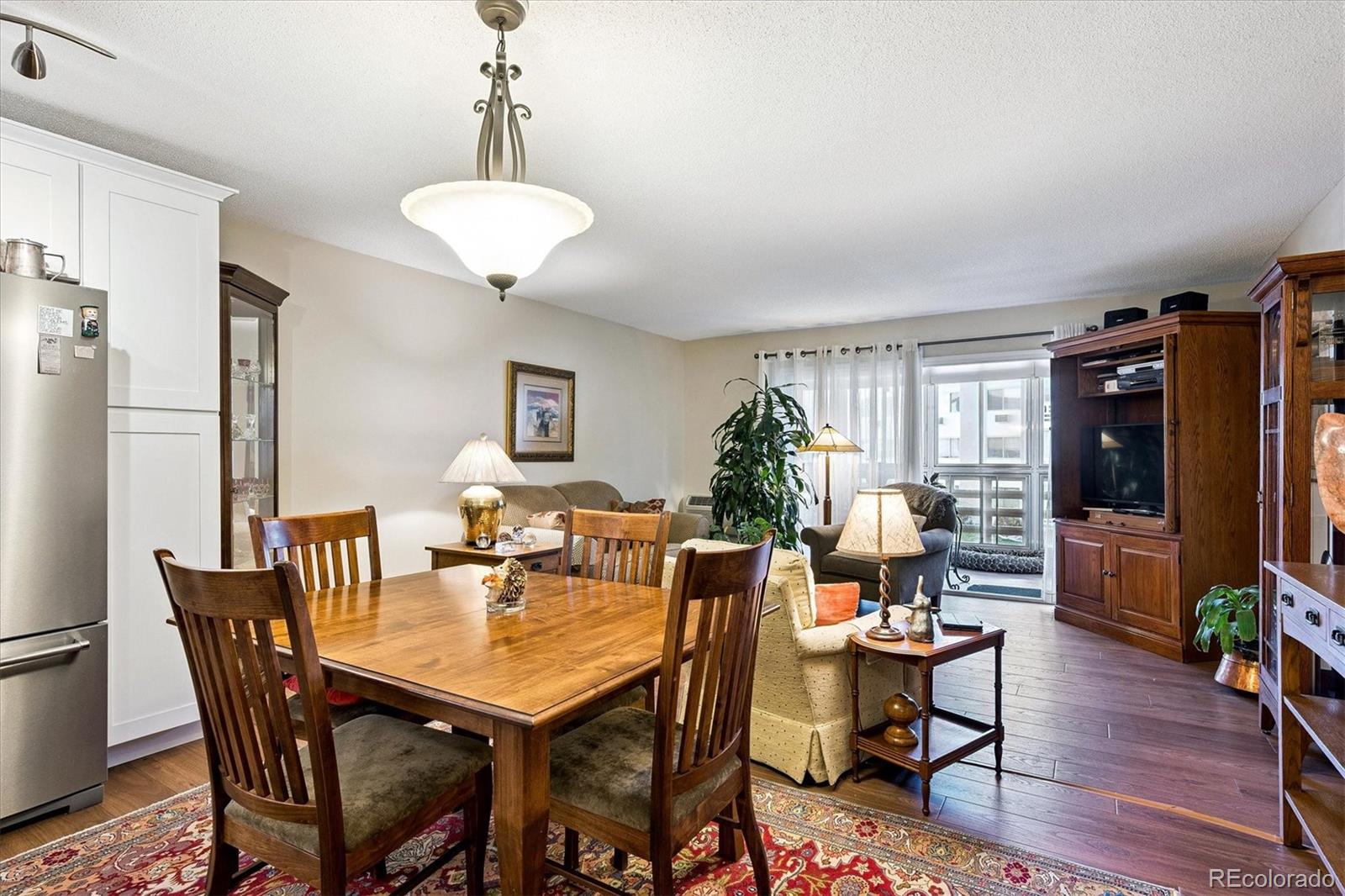 9625 Center Avenue, Unit 7B Denver, CO 80247 - Photo 3 of 49 a view of a dining room with furniture window and wooden floor