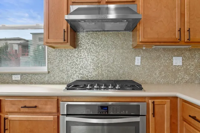 a kitchen with a stove and cabinets
