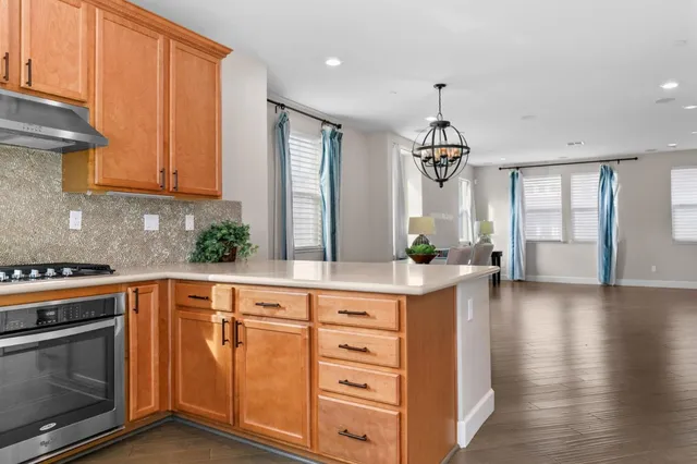 a kitchen with a stove oven and sink