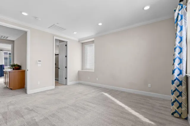an empty room with closet and a bathroom