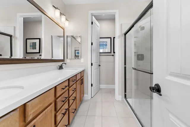 a bathroom with a double vanity sink and mirror