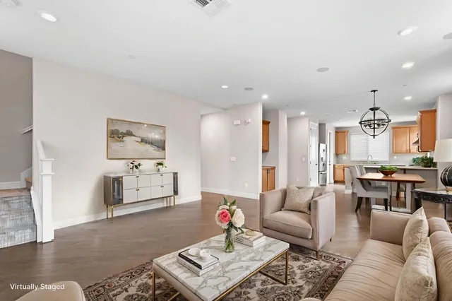 a living room with furniture and kitchen view
