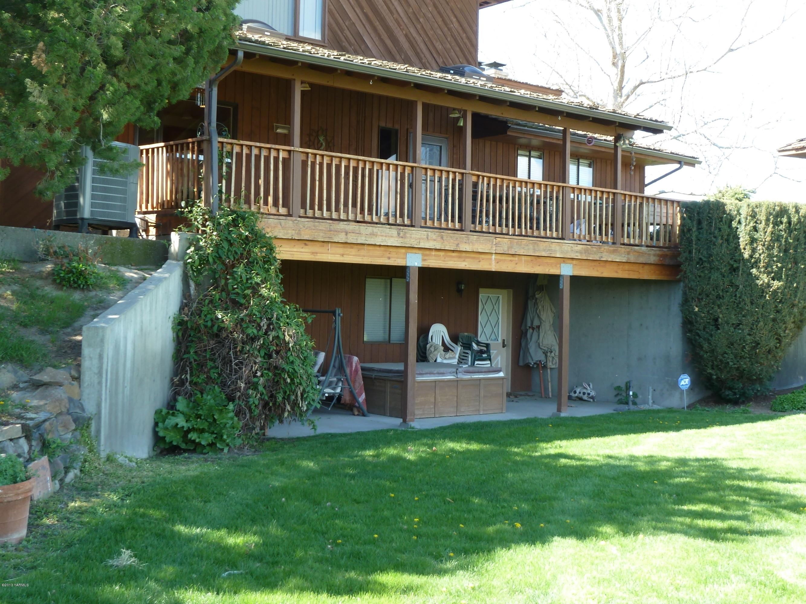 2280 Cemetery Road Sunnyside, WA 98944 - Photo 23 of 43 a view of a house with brick walls and a yard with plants
