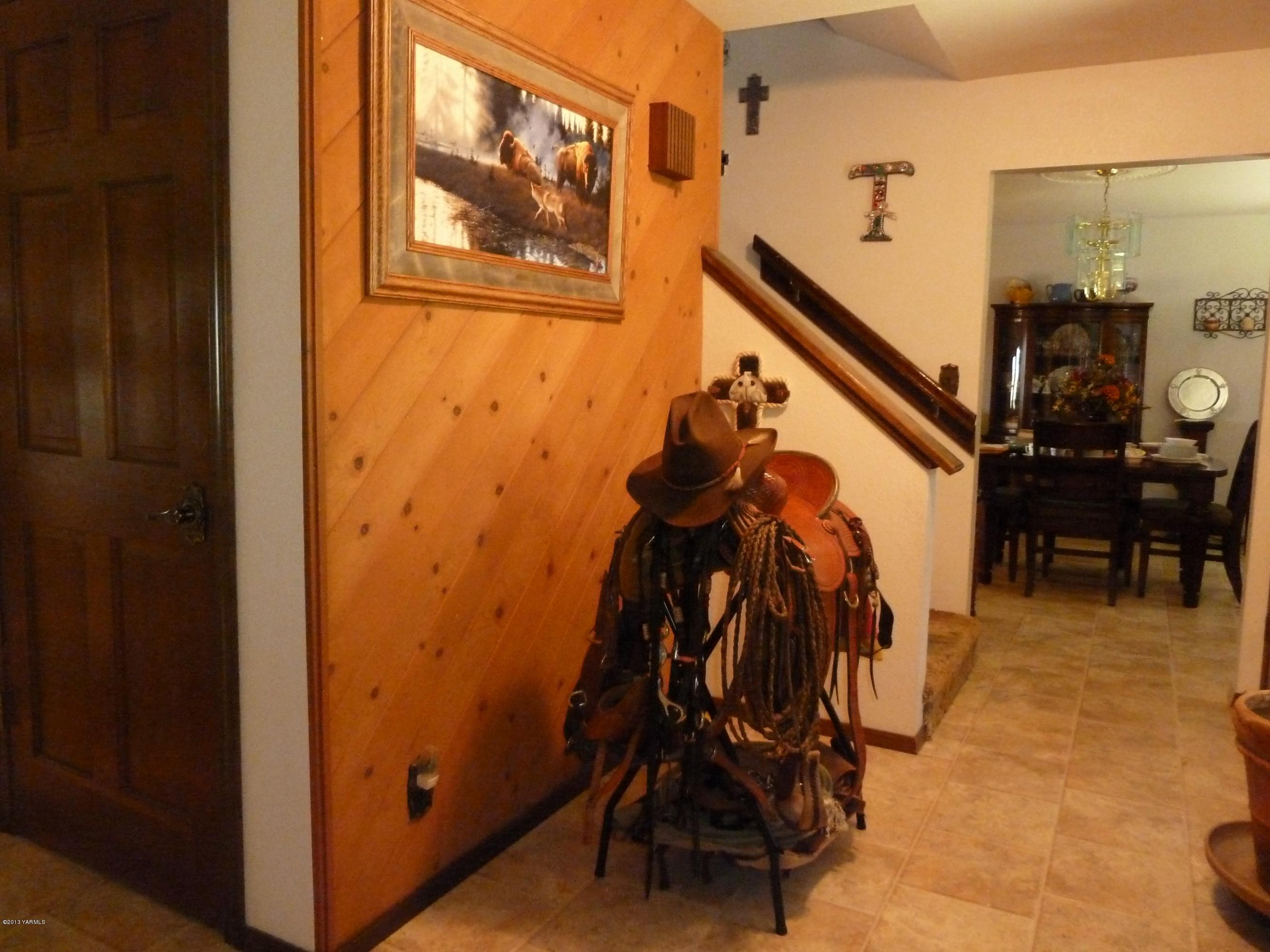 2280 Cemetery Road Sunnyside, WA 98944 - Photo 39 of 43 a view of a hallway with wooden floor and stairs