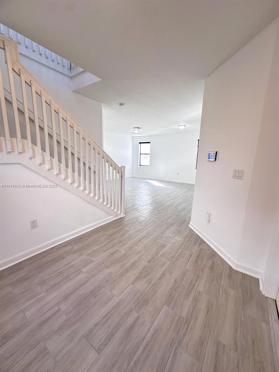 244 Northeast 210th Way, Unit 244 Miami, FL 33179 - Photo 13 of 32 a view of an entryway with wooden floor
