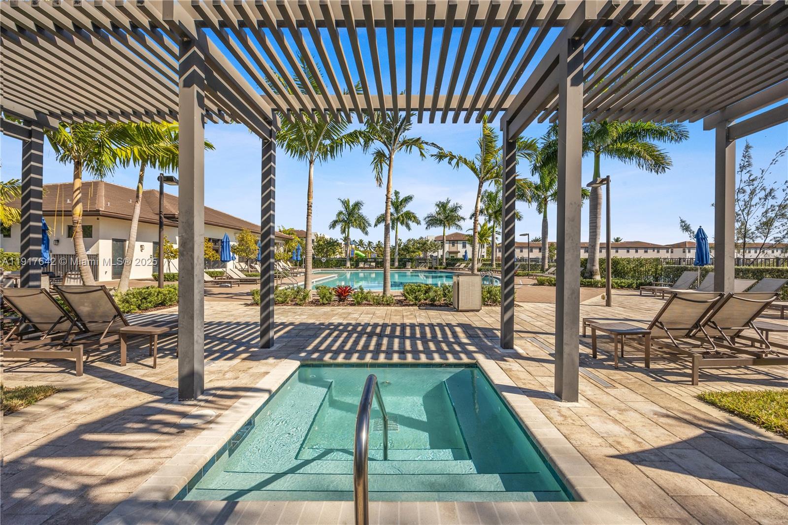 244 Northeast 210th Way, Unit 244 Miami, FL 33179 - Photo 26 of 32 a view of a swimming pool with a patio