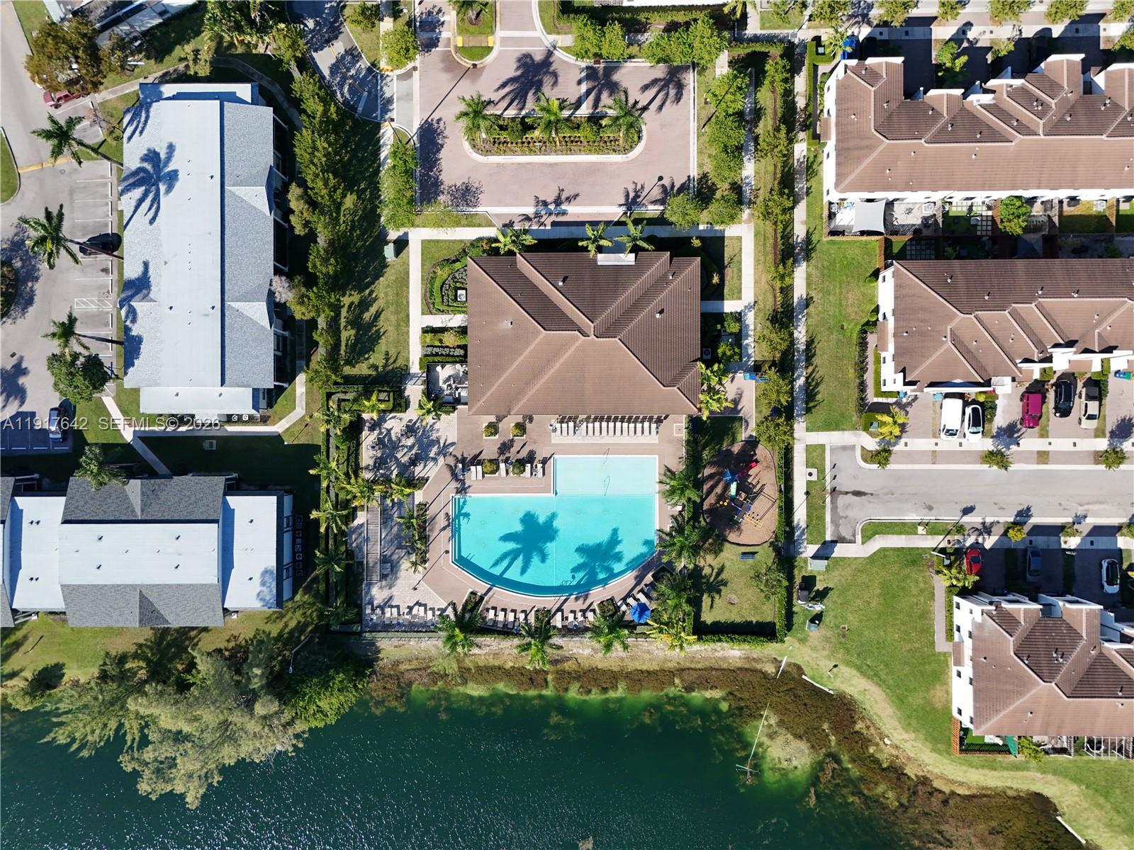 244 Northeast 210th Way, Unit 244 Miami, FL 33179 - Photo 31 of 32 an aerial view of a house with a yard and a large tree