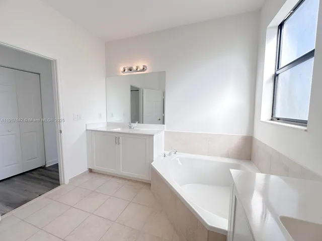 a bathroom with a bathtub and a sink