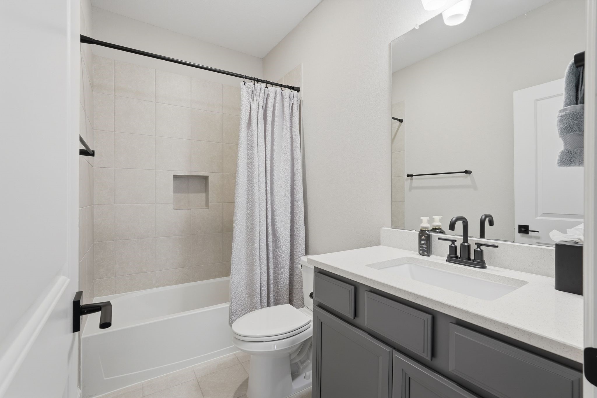 24423 Morningside Terrace Tomball, TX 77375 - Photo 42 of 47 a bathroom with a sink a toilet a mirror a bathtub and shower