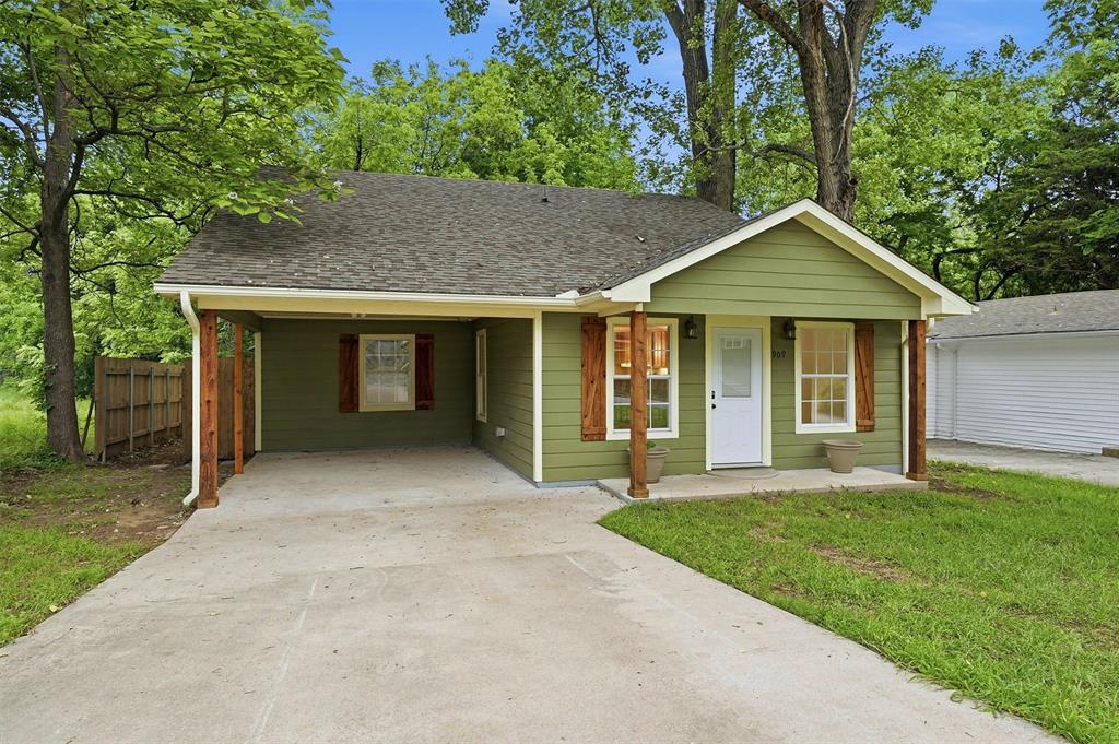 909 Thatcher Street Denison, TX 75020 - Photo 1 of 24 a front view of a house with a yard and garage