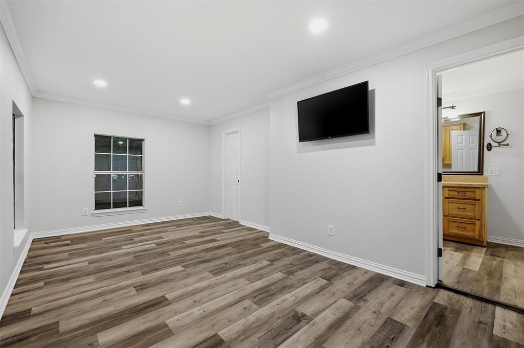 909 Thatcher Street Denison, TX 75020 - Photo 12 of 24 a view of a livingroom with wooden floor and flat screen tv