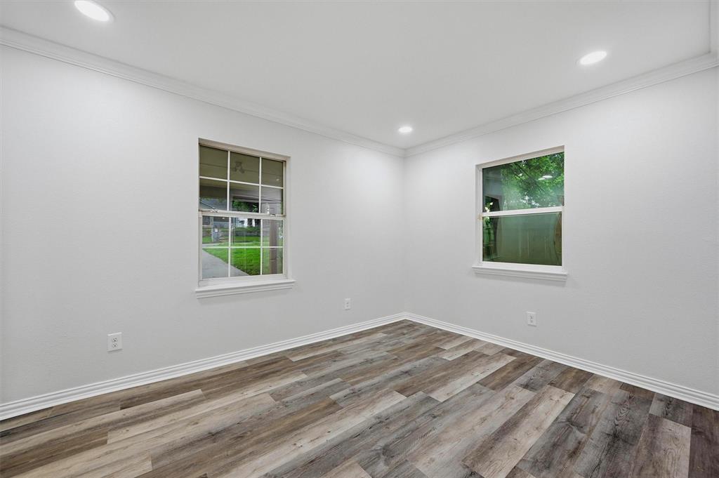 909 Thatcher Street Denison, TX 75020 - Photo 14 of 24 an empty room with windows