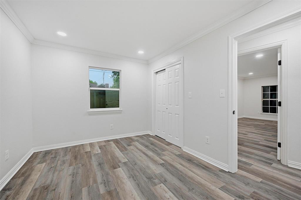 909 Thatcher Street Denison, TX 75020 - Photo 15 of 24 wooden floor in an empty room with a window