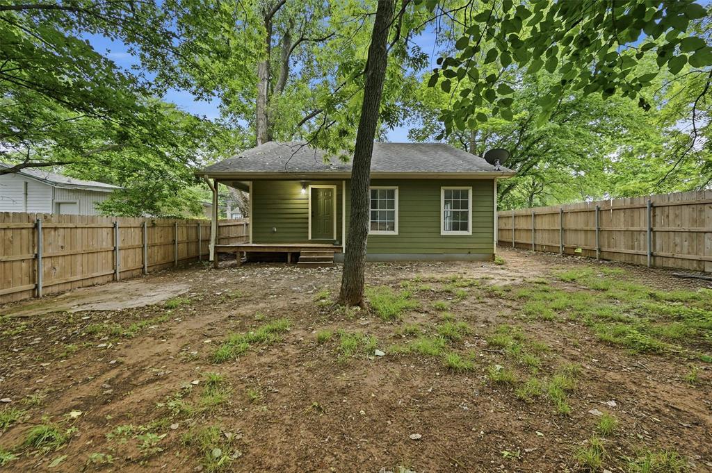 909 Thatcher Street Denison, TX 75020 - Photo 20 of 24 a backyard of a house with lots of green space