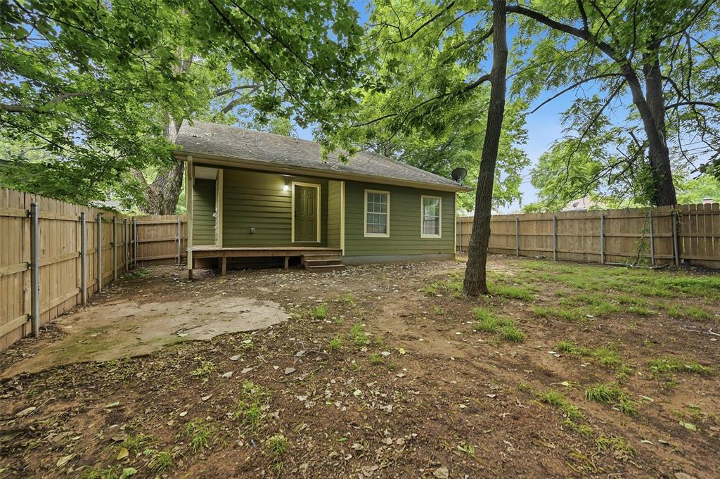 909 Thatcher Street Denison, TX 75020 - Photo 21 of 24 a view of a house with a yard and a large tree