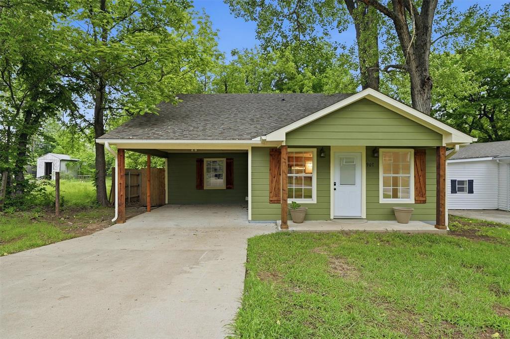 909 Thatcher Street Denison, TX 75020 - Photo 22 of 24 a front view of a house with a yard and porch