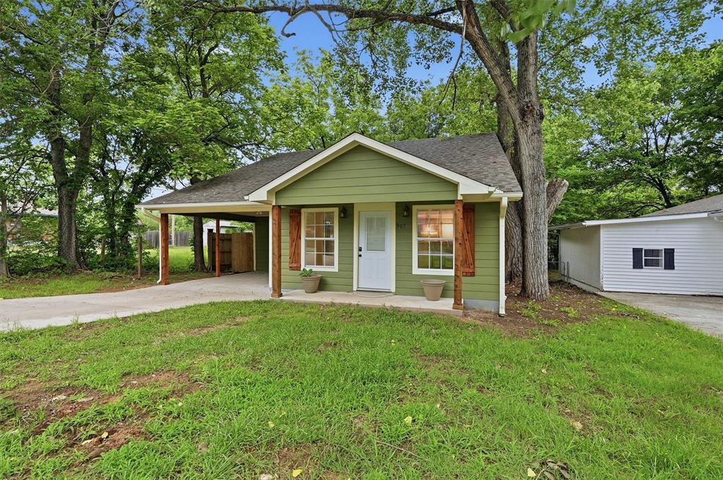 909 Thatcher Street Denison, TX 75020 - Photo 23 of 24 front view of a house with a yard