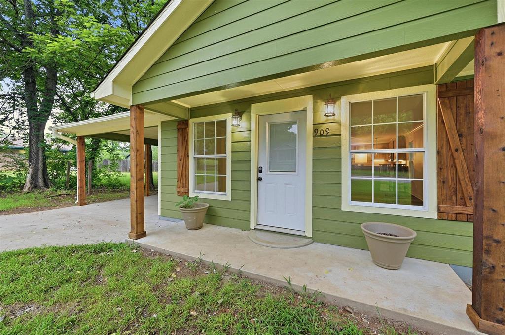 909 Thatcher Street Denison, TX 75020 - Photo 24 of 24 a front view of a house having yard