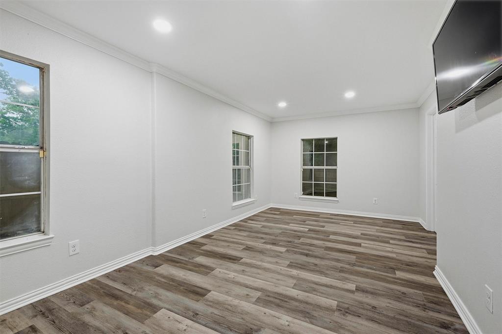 909 Thatcher Street Denison, TX 75020 - Photo 10 of 24 a view of empty room with wooden floor and fan
