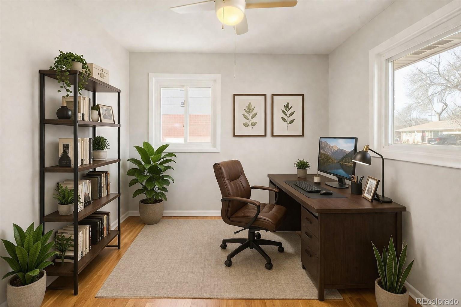 2438 South Perry Street Denver, CO 80219 - Photo 11 of 24 a view of a workspace with furniture and a potted plant