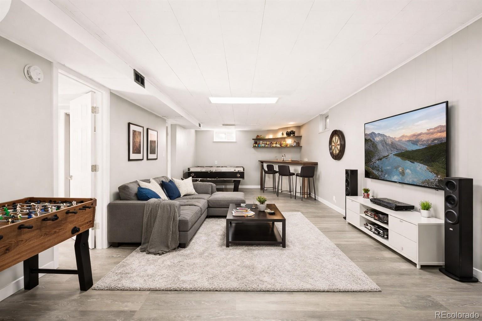 2438 South Perry Street Denver, CO 80219 - Photo 13 of 24 a living room with furniture and a flat screen tv