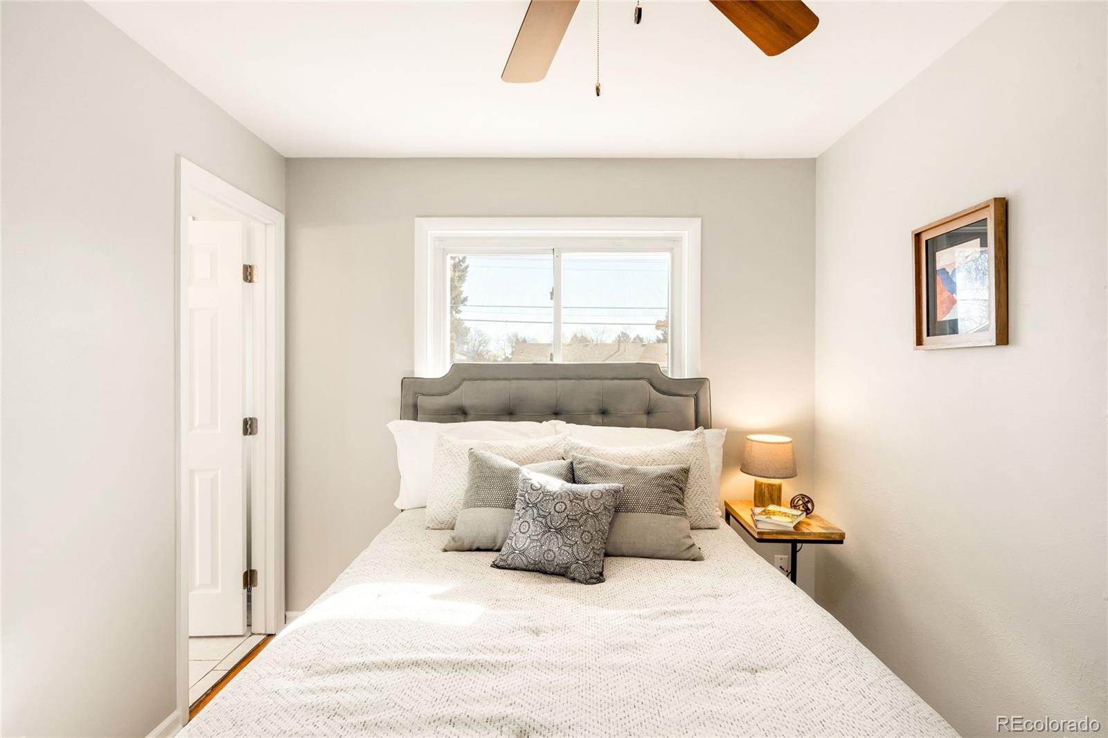 2438 South Perry Street Denver, CO 80219 - Photo 7 of 23 a large white bed in a white room