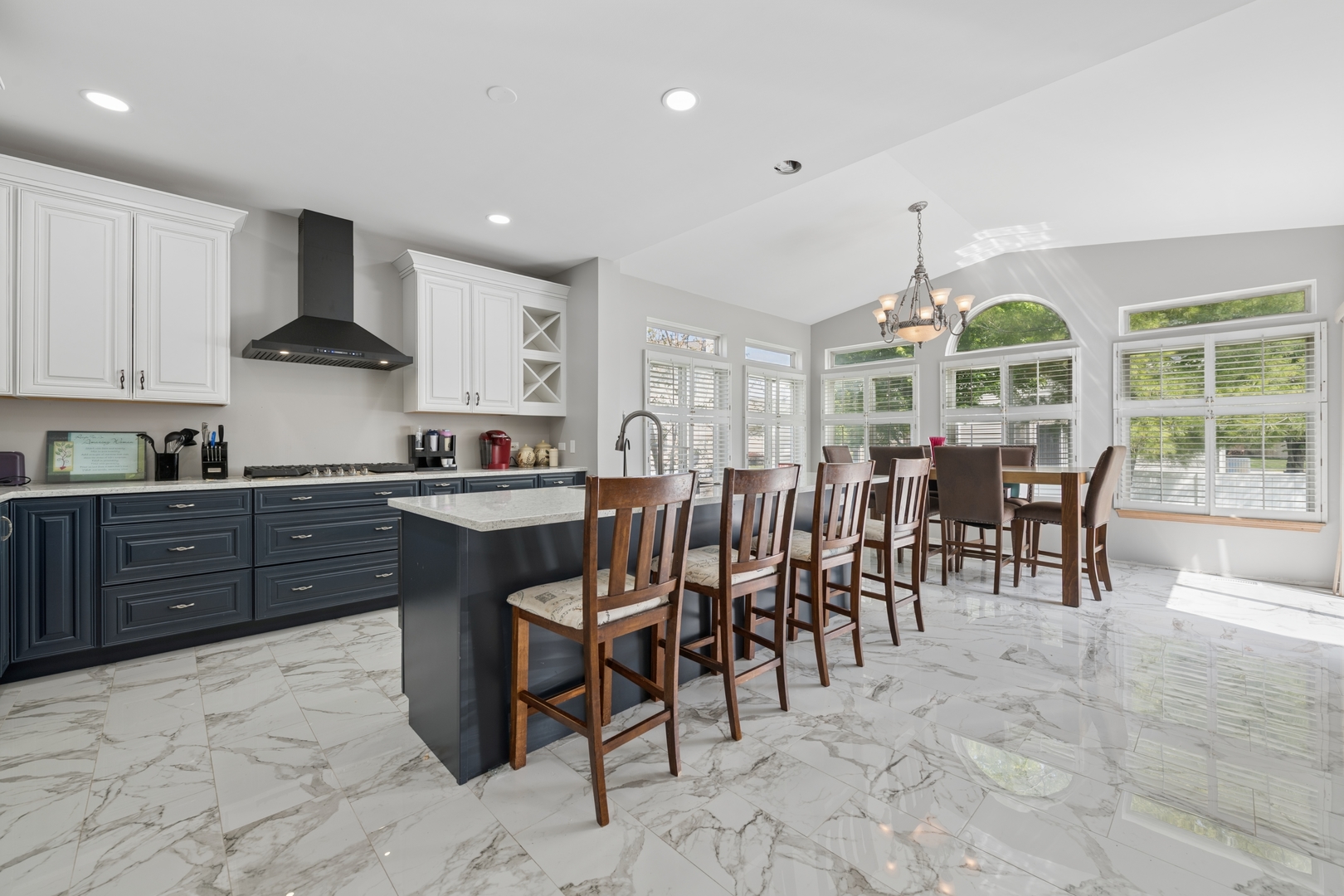 2014 Fieldstone Court Plainfield, IL 60586 - Photo 2 of 25 a kitchen with stainless steel appliances granite countertop a stove top oven a sink dishwasher a dining table and chairs with wooden floor