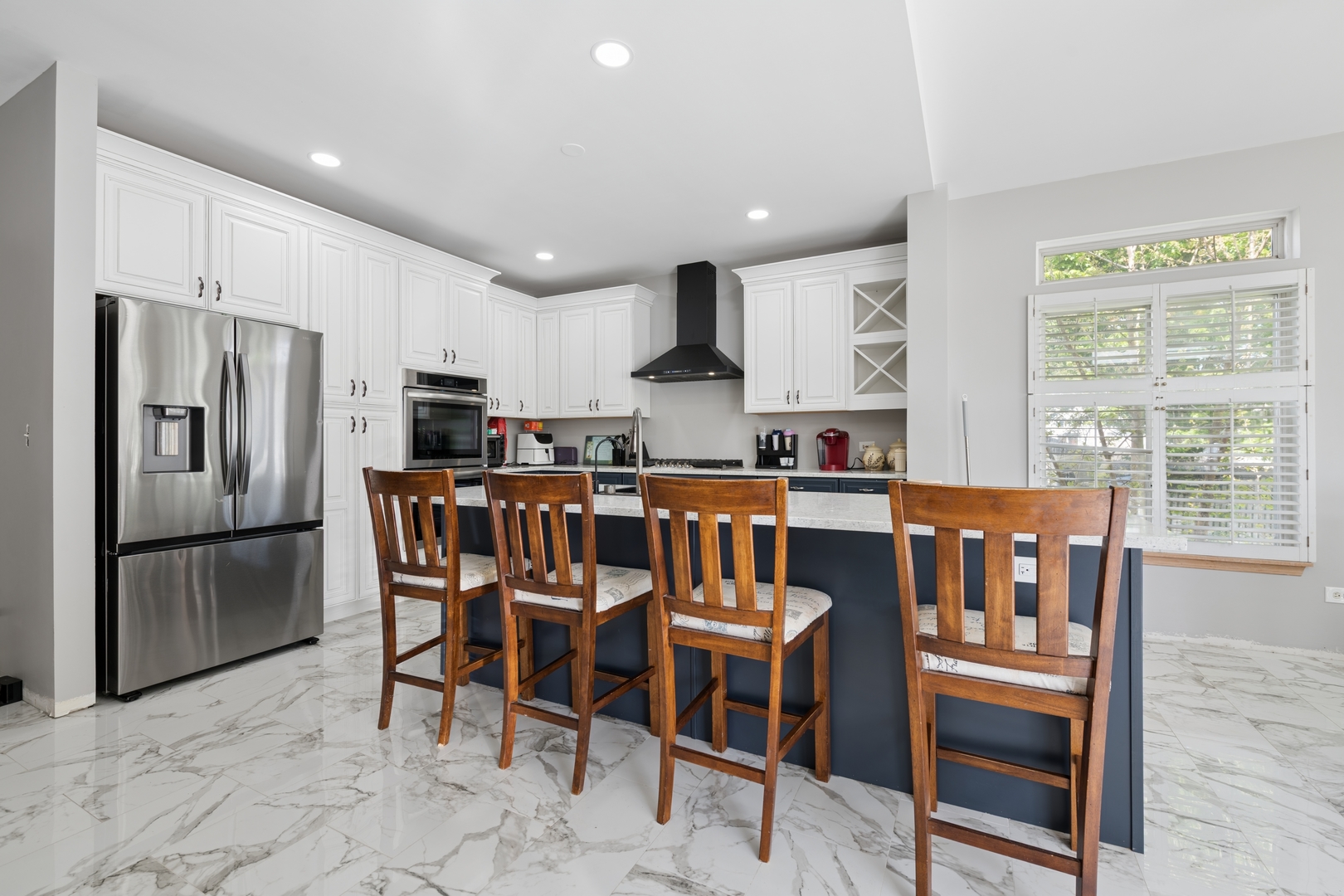 2014 Fieldstone Court Plainfield, IL 60586 - Photo 5 of 25 a kitchen with stainless steel appliances granite countertop a dining table chairs refrigerator and sink