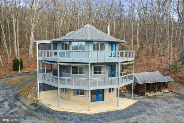 a view of a house with a yard and wooden deck