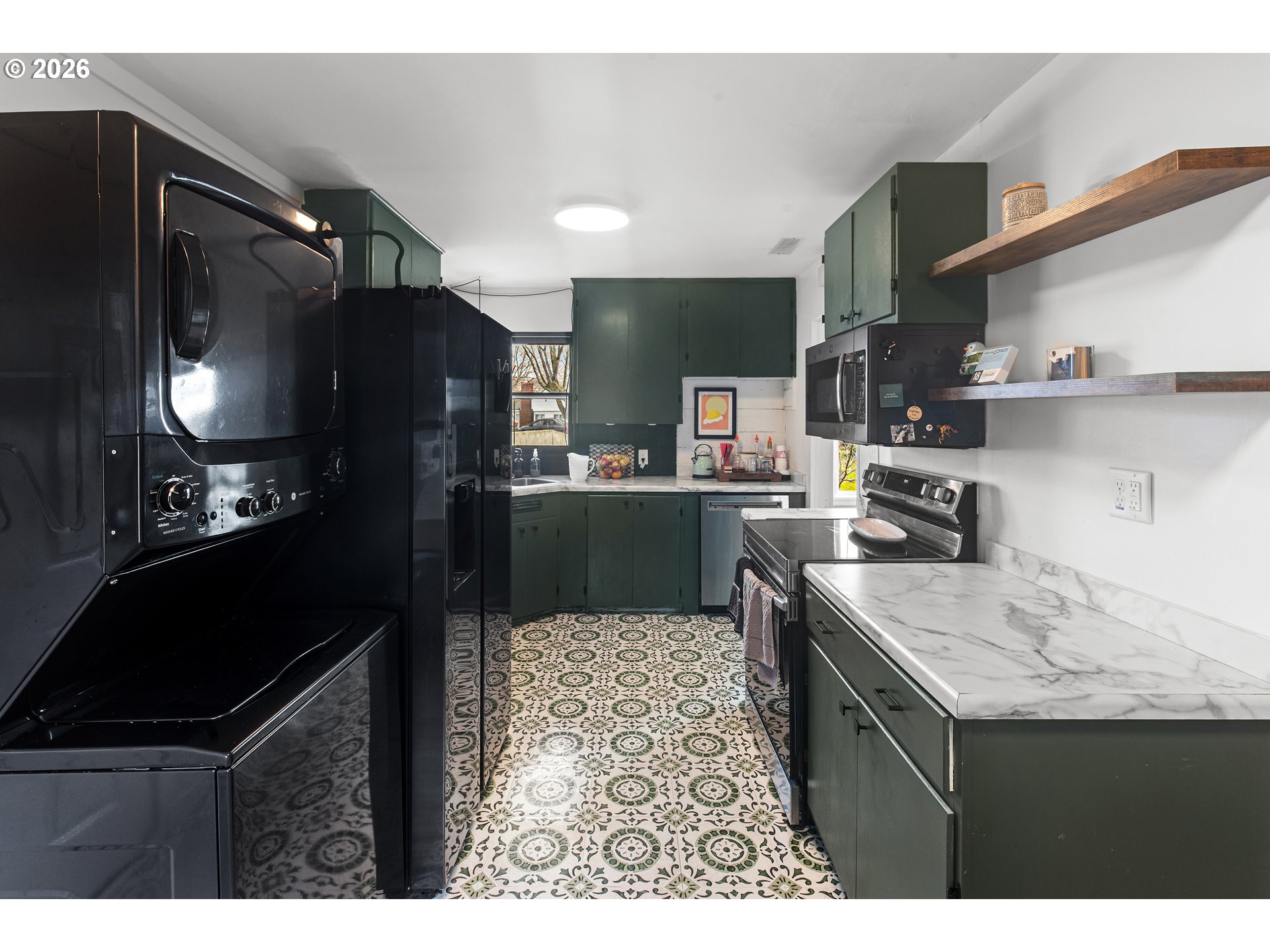 735 Northwest 10th Street Pendleton, OR 97801 - Photo 11 of 38 a kitchen with kitchen island granite countertop a sink stove and refrigerator