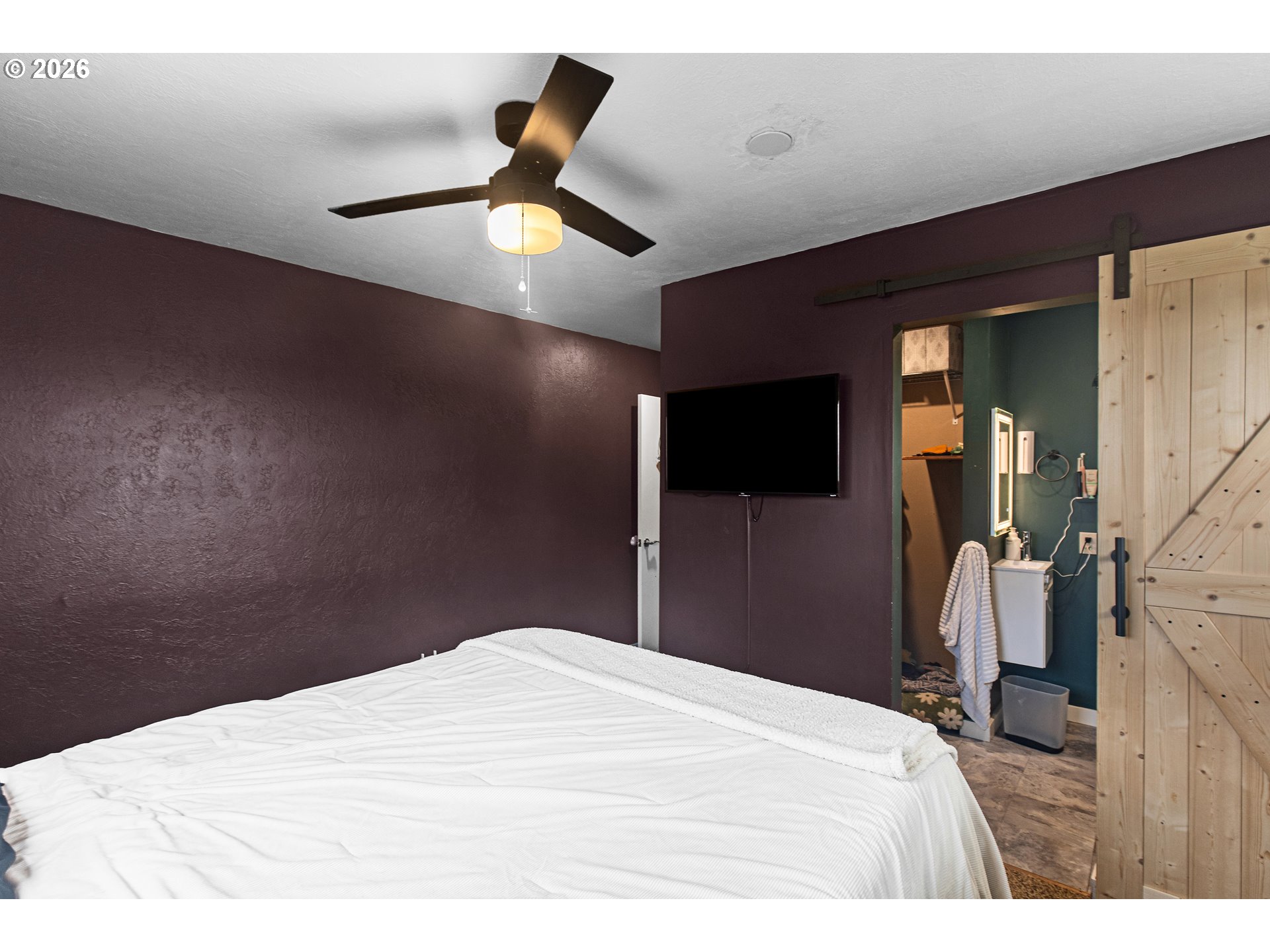 735 Northwest 10th Street Pendleton, OR 97801 - Photo 19 of 38 a bedroom with a bed and a flat tv screen