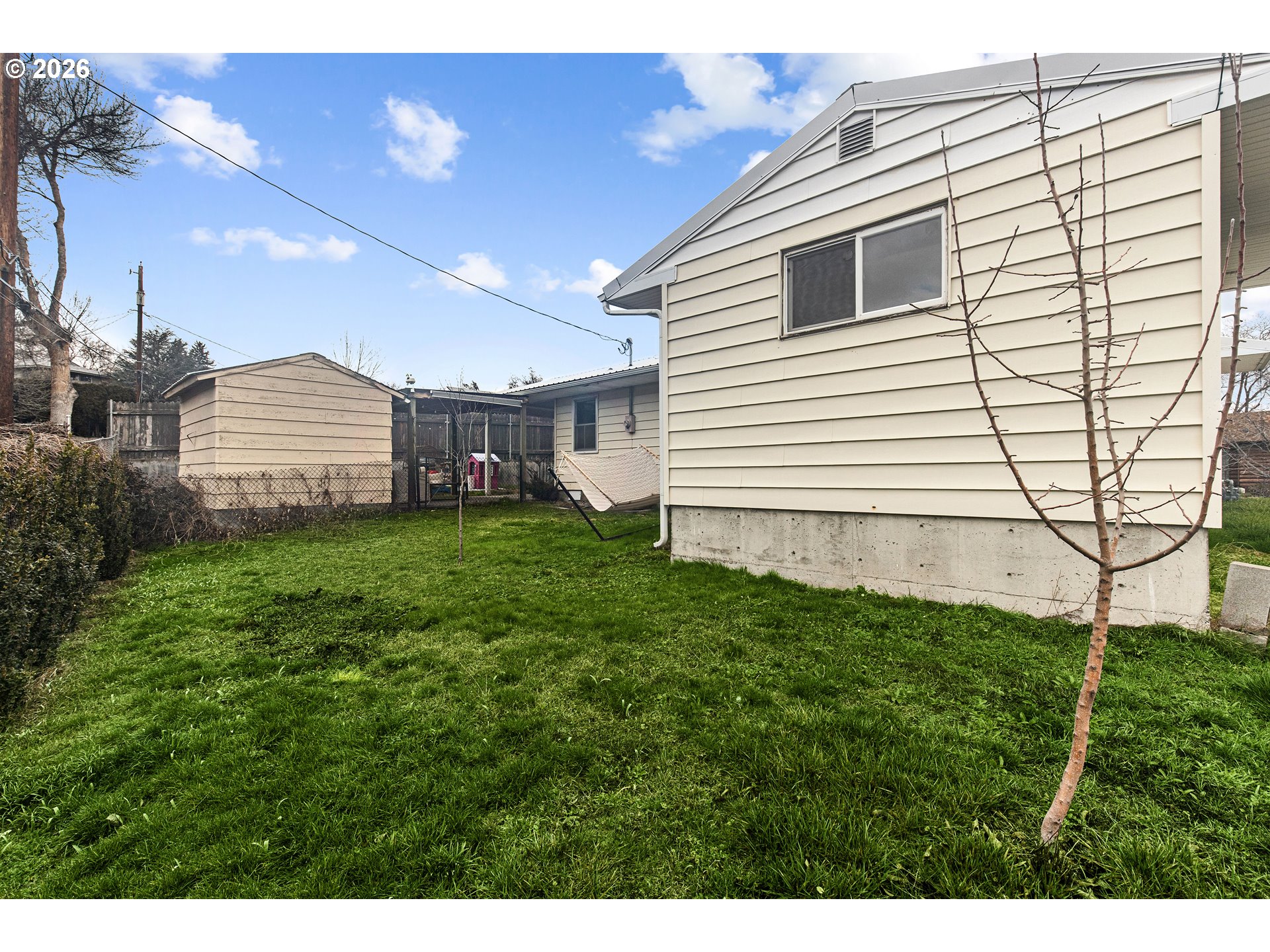 735 Northwest 10th Street Pendleton, OR 97801 - Photo 34 of 38 a view of a house with a backyard and a garden