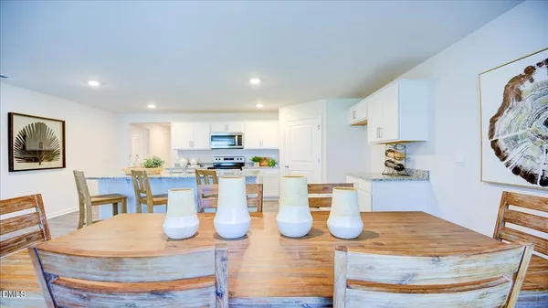 a dining room with wooden floor and glass table